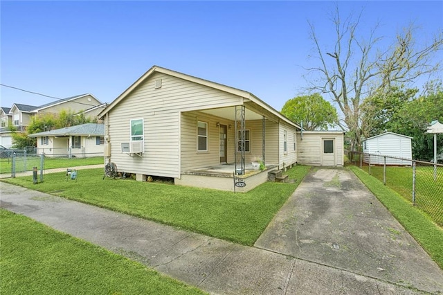 bungalow featuring a front lawn and cooling unit