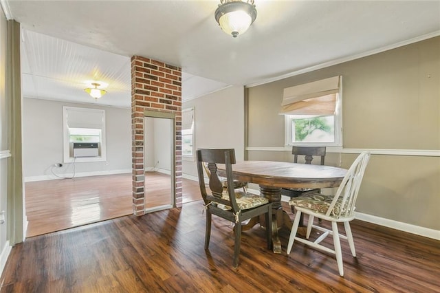 dining room with cooling unit, ornamental molding, and dark hardwood / wood-style flooring