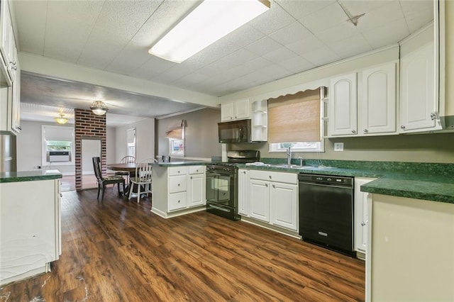 kitchen with black appliances, kitchen peninsula, and white cabinetry