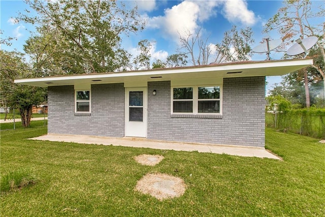 rear view of property with a lawn