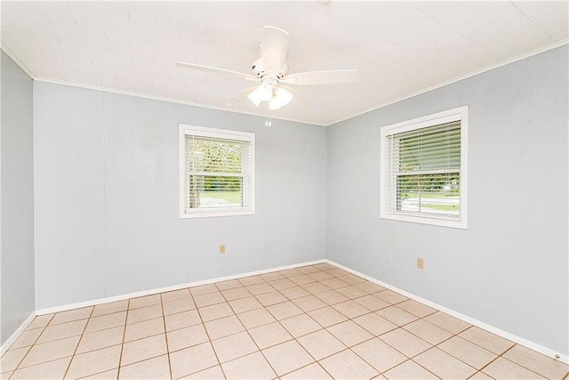 unfurnished room with ceiling fan, light tile patterned floors, plenty of natural light, and ornamental molding