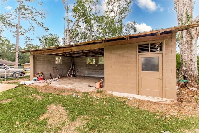 view of outbuilding featuring a lawn