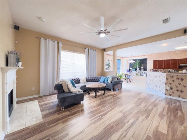 living room featuring ceiling fan, a healthy amount of sunlight, and hardwood / wood-style floors