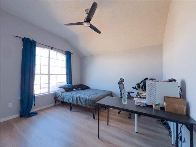 bedroom featuring ceiling fan, lofted ceiling, and wood-type flooring