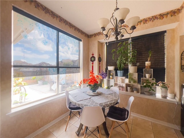 tiled dining space featuring a notable chandelier