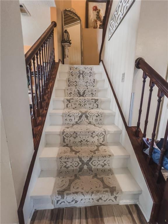 stairway featuring hardwood / wood-style floors