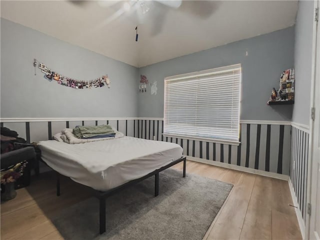 bedroom with ceiling fan and wood-type flooring