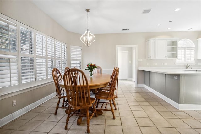 dining area with a chandelier, light tile patterned floors, visible vents, and baseboards