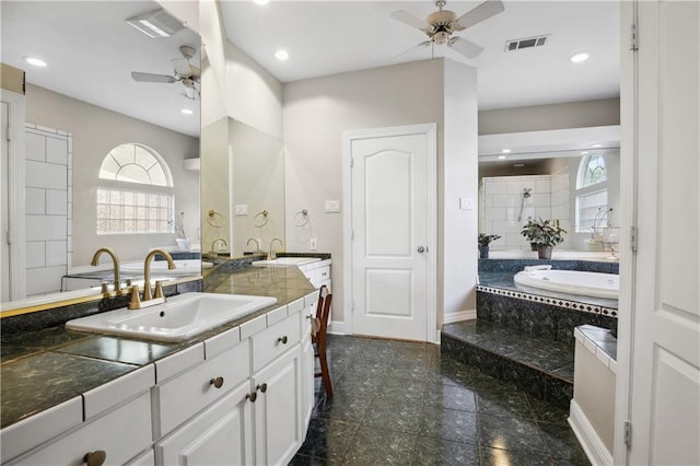 full bath featuring ceiling fan, a sink, visible vents, and a wealth of natural light