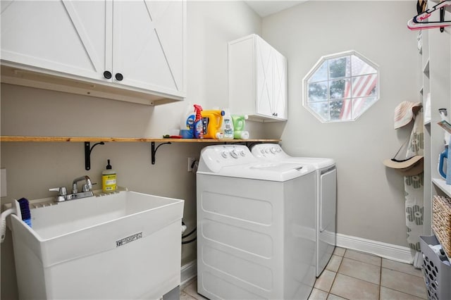 washroom featuring light tile patterned floors, independent washer and dryer, cabinets, and sink