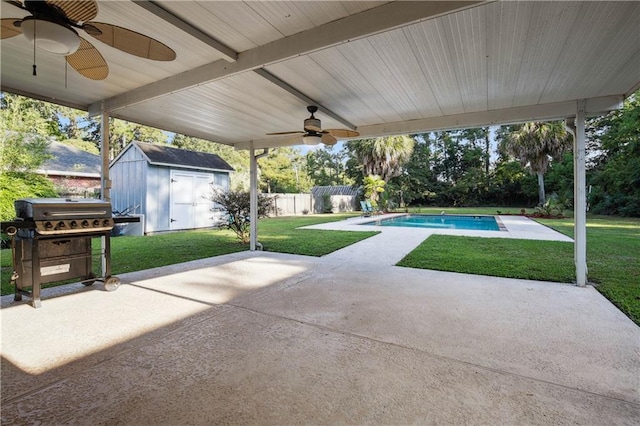 view of patio / terrace featuring a grill, a fenced in pool, a storage shed, and ceiling fan