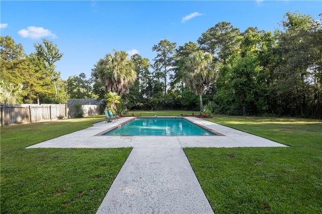 view of pool featuring a yard and a patio