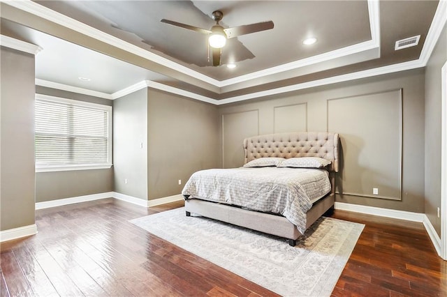 bedroom featuring dark wood-type flooring, ceiling fan, and ornamental molding