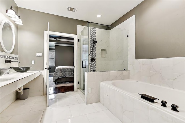 bathroom featuring separate shower and tub and hardwood / wood-style flooring