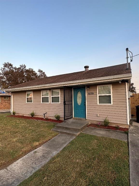 ranch-style house with a front lawn