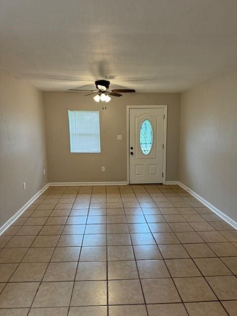 tiled entryway featuring ceiling fan