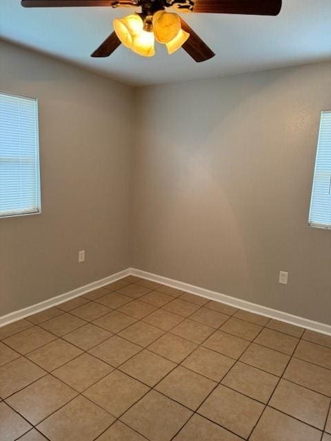 empty room featuring light tile patterned floors and ceiling fan