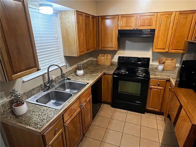 kitchen featuring black range with electric stovetop, sink, range hood, and light tile patterned flooring