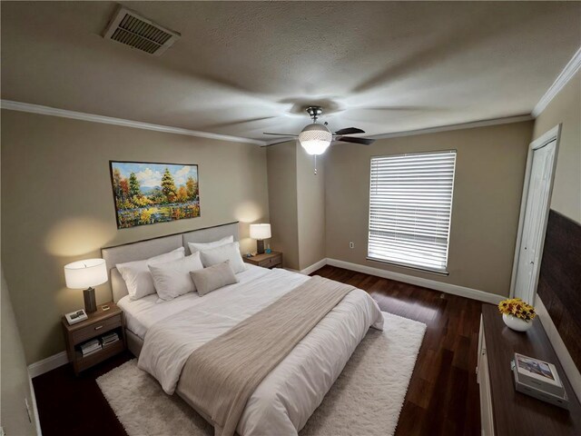 bedroom featuring ceiling fan, a closet, dark hardwood / wood-style flooring, and ornamental molding