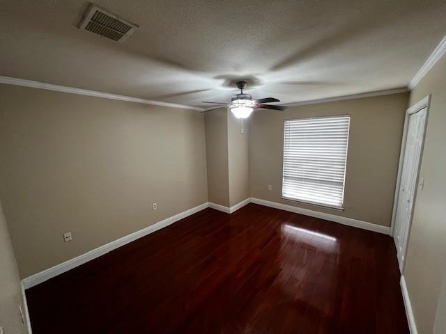 unfurnished room featuring ceiling fan, a textured ceiling, dark hardwood / wood-style flooring, and crown molding