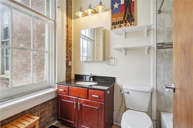 full bathroom with toilet, tiled shower / bath combo, and vanity