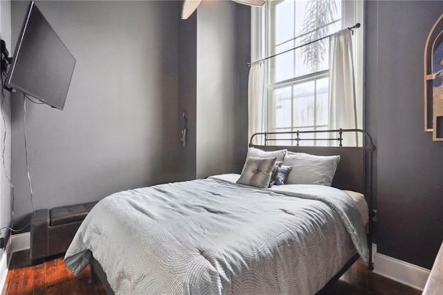 bedroom with dark hardwood / wood-style floors