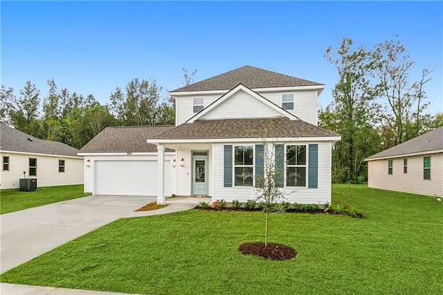 view of front of property with a front lawn, central AC unit, and a garage