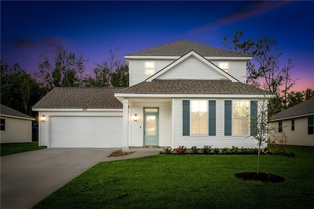 front of property featuring a lawn and a garage