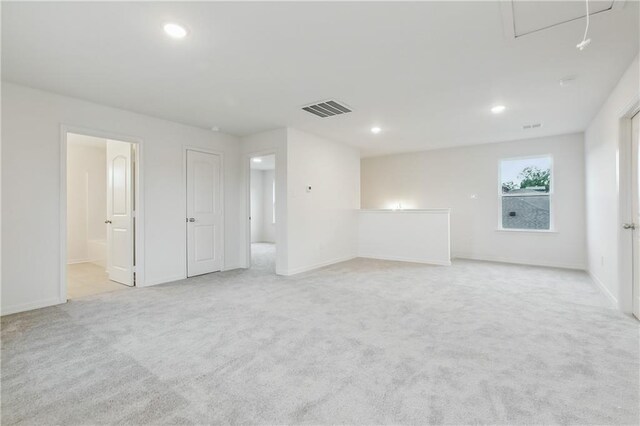 unfurnished room featuring light carpet