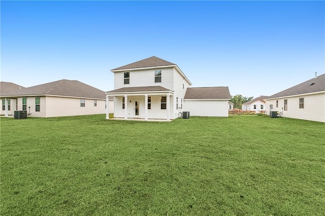 back of house featuring a lawn and central AC unit