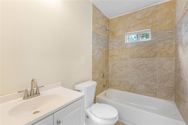 full bathroom featuring vanity, tiled shower / bath combo, and toilet