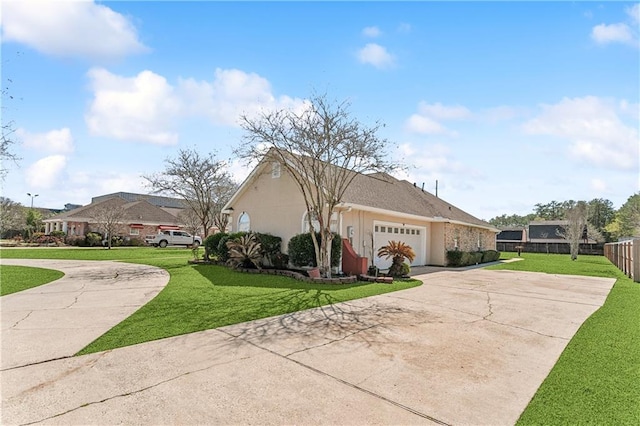 ranch-style house featuring a front yard and a garage