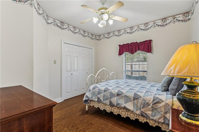 bedroom featuring ceiling fan, a closet, and dark wood-type flooring