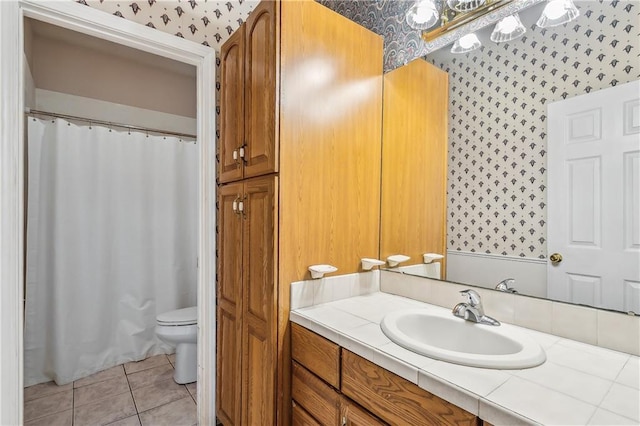 bathroom featuring vanity, tile patterned flooring, and toilet