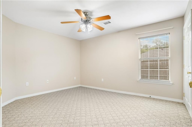 carpeted spare room featuring ceiling fan