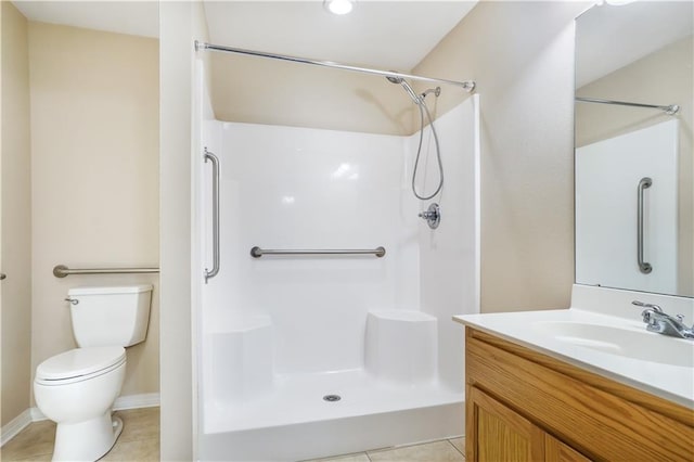 bathroom with a shower, toilet, vanity, and tile patterned floors