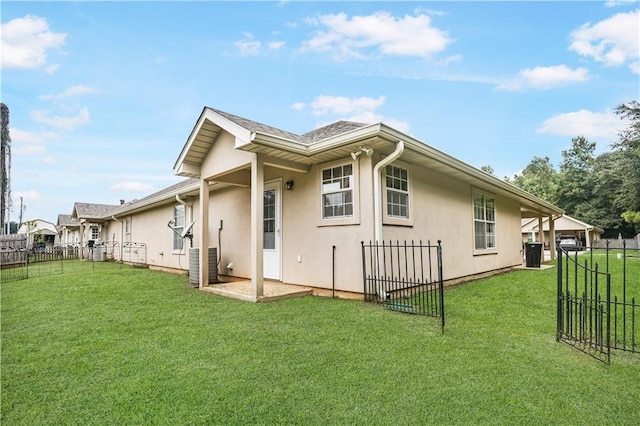 rear view of property with a yard