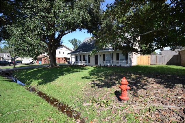 view of front of property with covered porch and a front yard