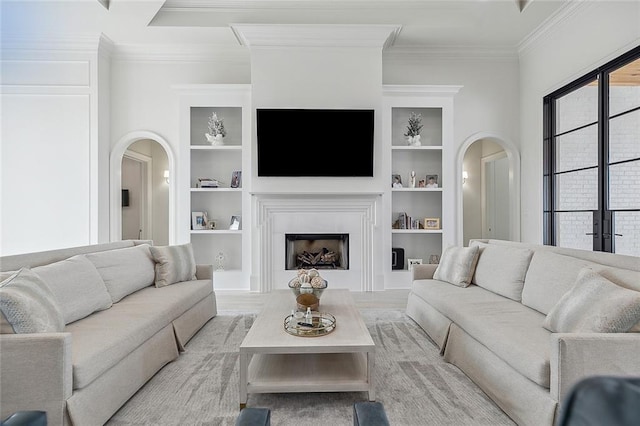 living room with light wood-type flooring, crown molding, and built in shelves