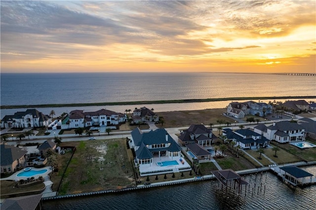 aerial view at dusk with a water view