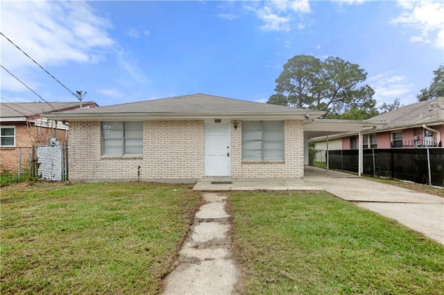 view of front of house with a front yard and a carport