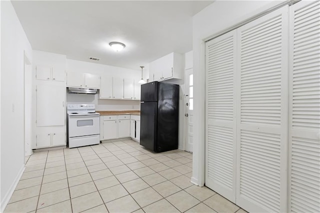 kitchen with electric range, white cabinets, black refrigerator, and light tile patterned flooring