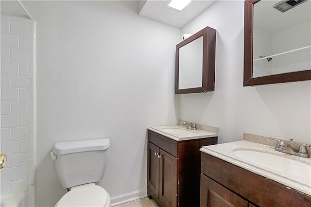 bathroom with vanity, toilet, and a shower