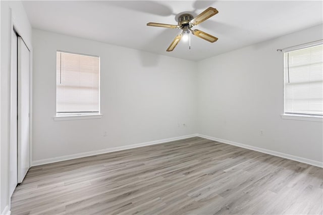 unfurnished bedroom with ceiling fan, a closet, and light hardwood / wood-style floors