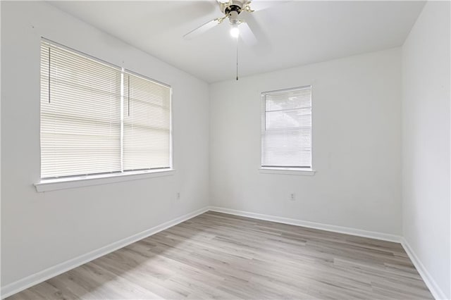 spare room featuring light wood-type flooring and ceiling fan