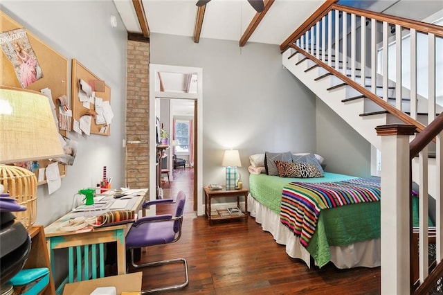 bedroom with dark hardwood / wood-style flooring and beamed ceiling