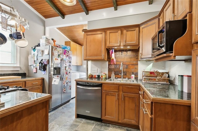 kitchen with tasteful backsplash, sink, stainless steel appliances, wooden ceiling, and washer and clothes dryer