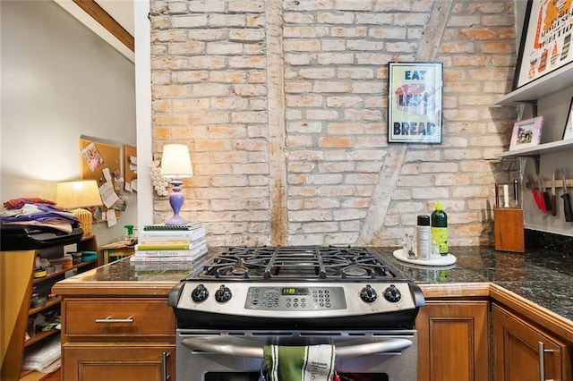 kitchen with gas stove and brick wall