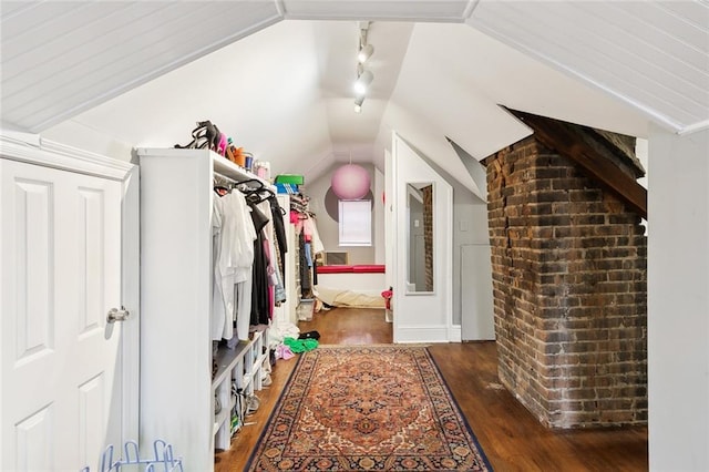 interior space featuring lofted ceiling and dark hardwood / wood-style floors