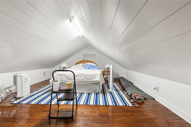 bedroom with lofted ceiling and hardwood / wood-style floors